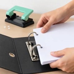 Hojas A4 perforadas con la Grap 583 colocándose en los anillos de un bibliorato